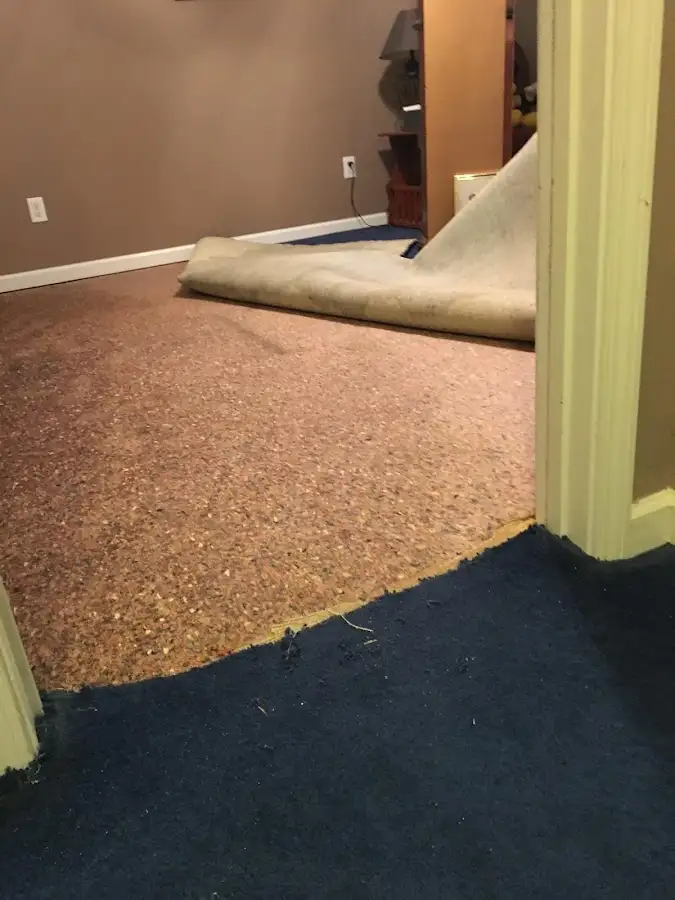 Carpet pad removal revealing water damage during Drying & Dehumidification in Old Forge