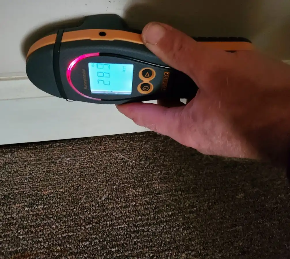 Moisture detection at baseboard during Storm Damage Restoration in Old Forge